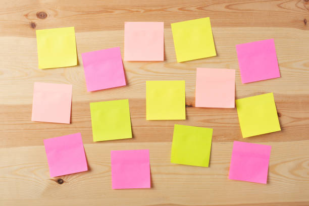 istock Blank colorful papers on a wooden board 1289570672