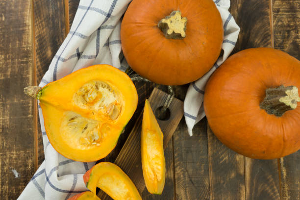 istock autumn background with pumpkin on wooden board 1289570720