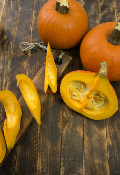 istock autumn background with pumpkin on wooden board 1289570835