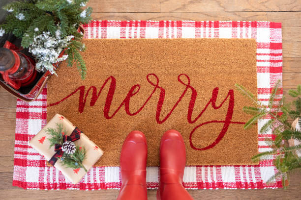 istock Holiday welcome mat with red boots 1289571004