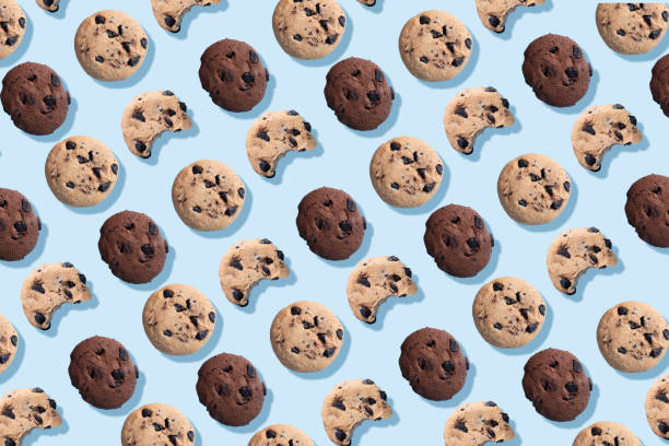 istock A pattern of chocolate chip cookies on a blue background. 1289571933