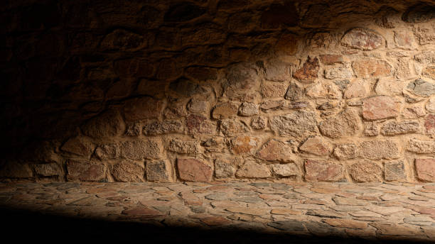istock Old stone wall for display of products against background, with sunlight. 1289572082