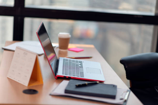 istock Workplace with laptop on table in the office 1289572096