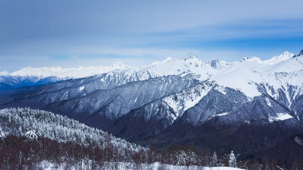 istock Panoramic view on high snowy mountains in winter at sunny day. Caucasus Mountains, Mount Ushba. Svaneti region of Georgia 1289573561