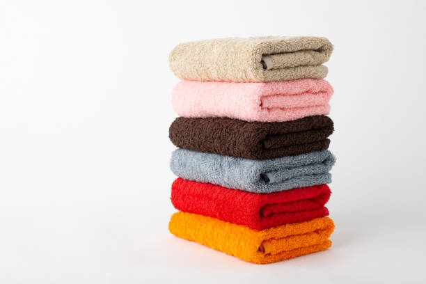 istock Stacked towels of different colour on a grey background 1289574287