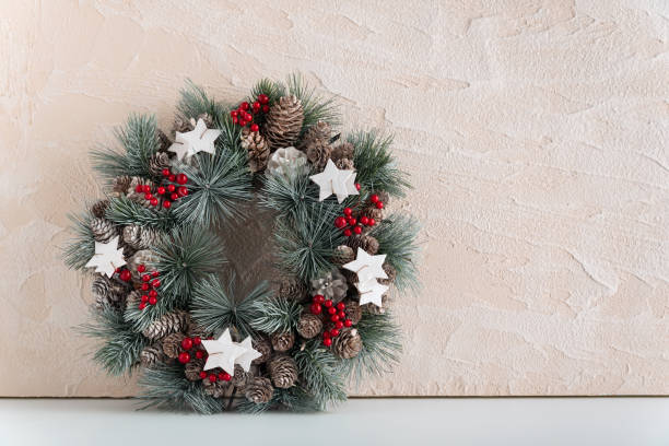 istock Beautiful Christmas wreath on light background. Copy space. Winter Holiday pattern 1289574610