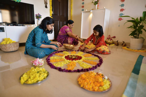 istock Multi-generation Indian family making floral rangoli for Diwali celebration 1289574659