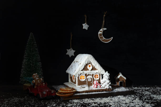 istock New Years composition: gingerbread house, toy car, artificial Christmas tree. 1289574841