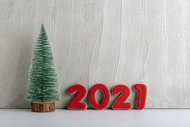 istock Small artificial Christmas tree and red numbers 2021. New year concept. Copy space 1289574876