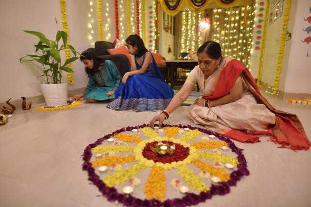 istock Multi-generation Indian family making floral rangoli for Diwali celebration 1289575847