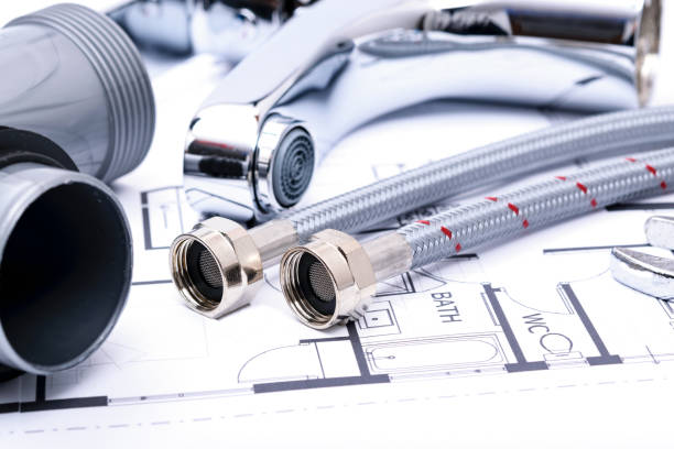 istock Plumbing equipment on a house plan 1289577291
