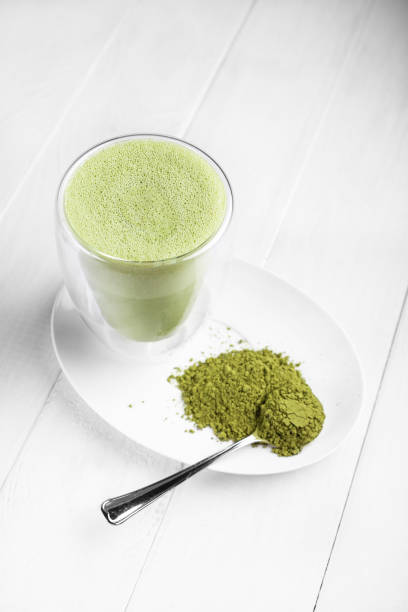 istock Matcha with milk in a glass on a light background 1289578192