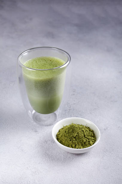 istock Matcha with milk in a glass on a light background 1289578208