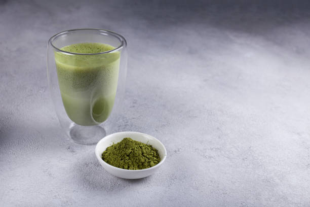 istock Matcha with milk in a glass on a light background 1289578222