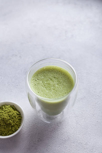 istock Matcha with milk in a glass on a light background 1289578224