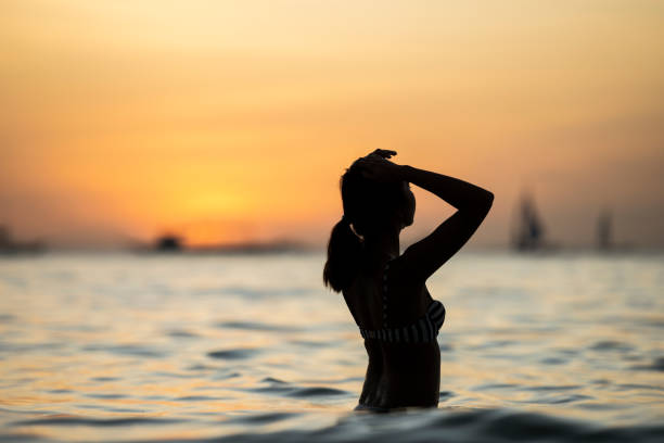 silueta de una chica admirando una puesta de sol impresionante. playa blanca de boracay. boracay, filipinas. - 7700 fotografías e imágenes de stock