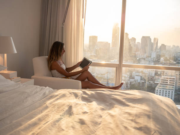 istock Woman using digital tablet in hotel room 1289582862