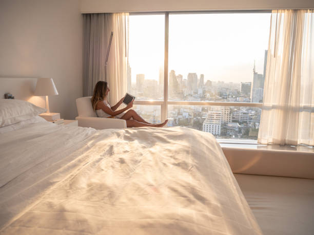 istock Woman using digital tablet in hotel room 1289582914