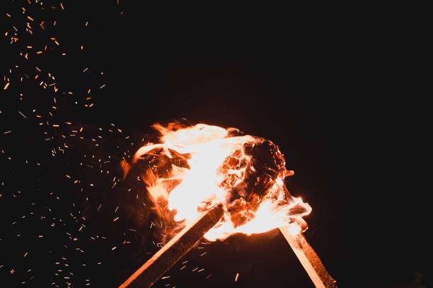 two burning torches on a dark background, smoke and fire from burning torches.