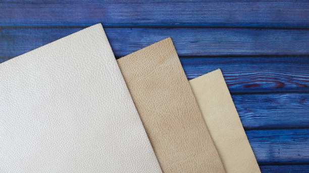 Natural leather textures samples on blue wooden background Different colors natural leather textures samples on blue wooden background leather white hide textured stock pictures, royalty-free photos & images