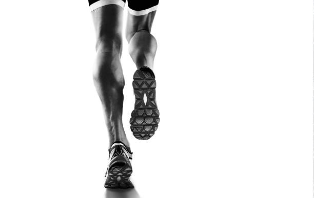 Sports background. Runner feet running closeup on shoe. Isolated on white. stock photo
