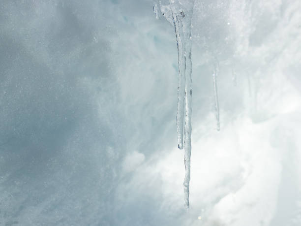 istock Icicles on snow background. Winter concept ideas 1289585371