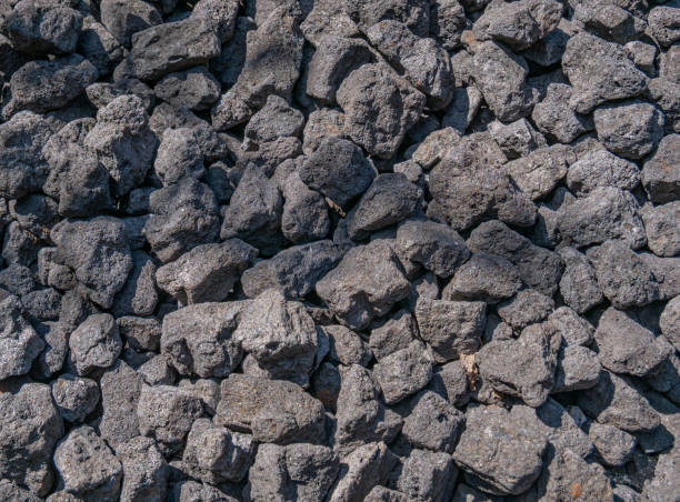 Small lumps of hard coal on a big pile Close up of small lumps of hard coal on a large pile coke coal stock pictures, royalty-free photos & images