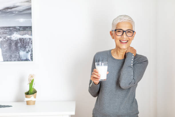 istock Senior woman drinking milk at home. 1289589405