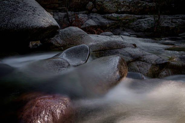 istock Water in a river flowing over boulders, long exposure 1289590216