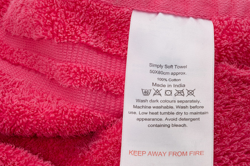 A label stitched on a towel with washing instructions