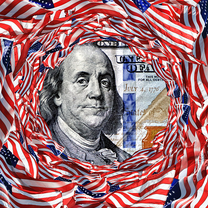 Conceptual finance image of large group of American flags and US dollar bills