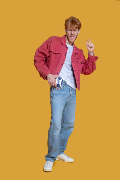 istock Young bearded good-looking man with old player looking enjoyed 1289594109