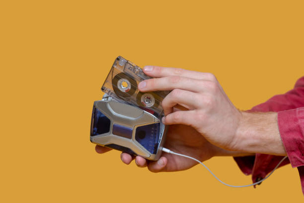 istock Picture of a man inserting the cassette into player 1289594129