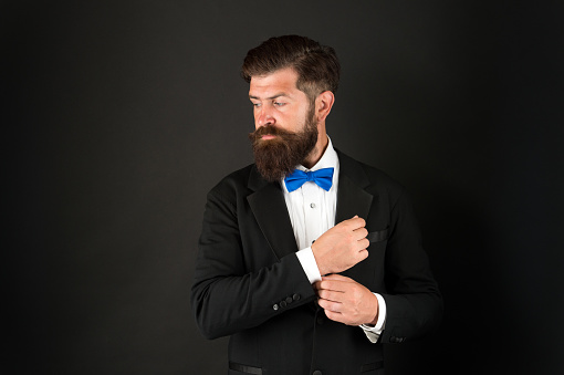 Wedding day concept. Stylish groom. Elegant collection. Neat and tidy. Stylist fashion expert. Suit style. Fashion trends for groom. Groom bearded hipster man wear tuxedo and blue bow tie.