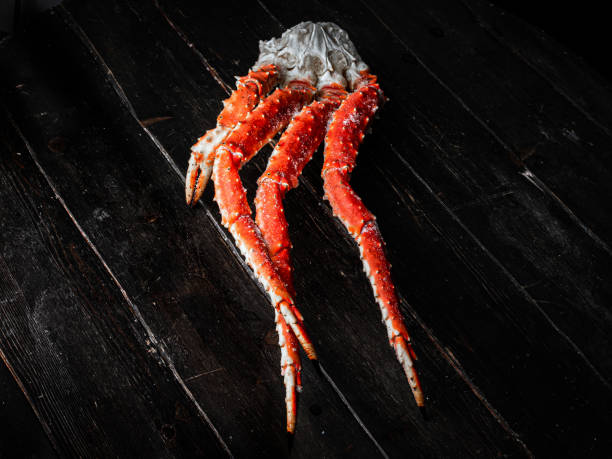 istock Fresh crab claws on vintage wooden background. 1289599772