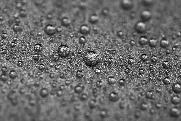 Photo of Abstract gray texture with water drops and metal surface close-up. Beautiful bright droplets shot with selective focus.