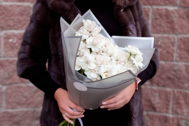istock Female hands with winter bouquet 1289601792