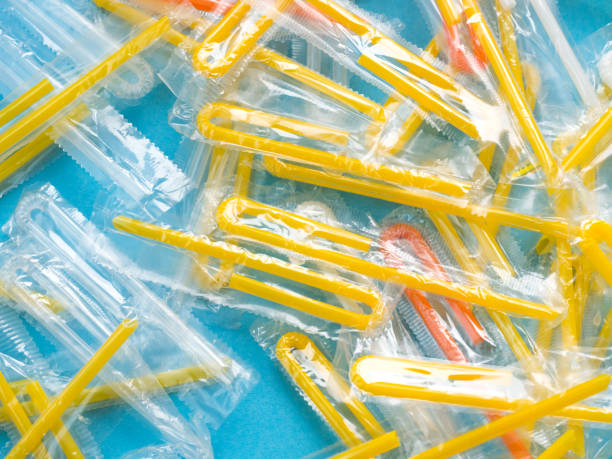istock Pile of yellow drinking straws on a blue background 1289603064