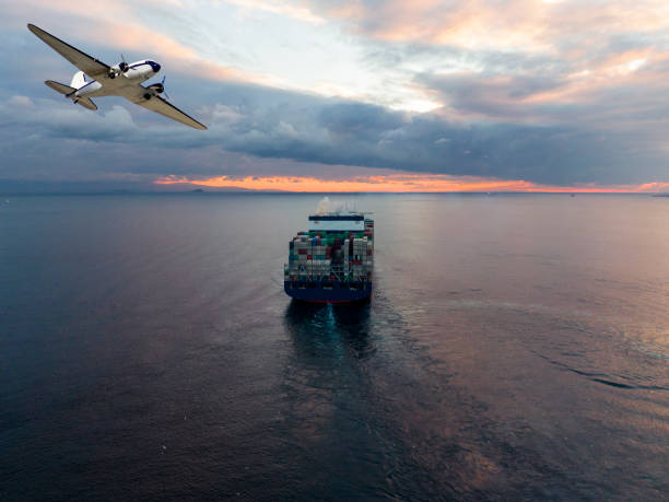 istock Cargo ship and cargo plane in the ocean at Sunset sky, Freight Transportation, Shipping 1289607892
