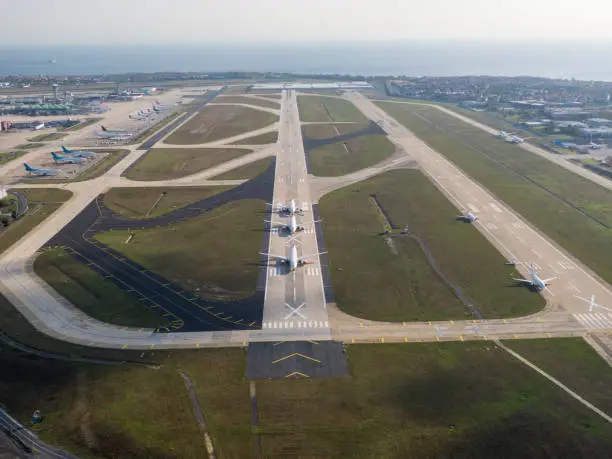 Photo of Aerial drone photo of air planes as seen from above docked in airport space