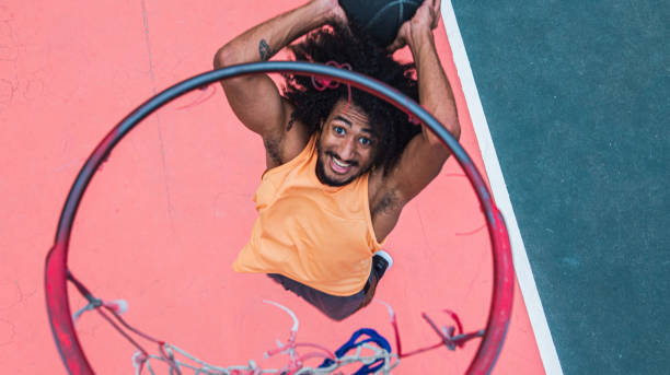 istock Young basketball player dunks on sport court 1289608524