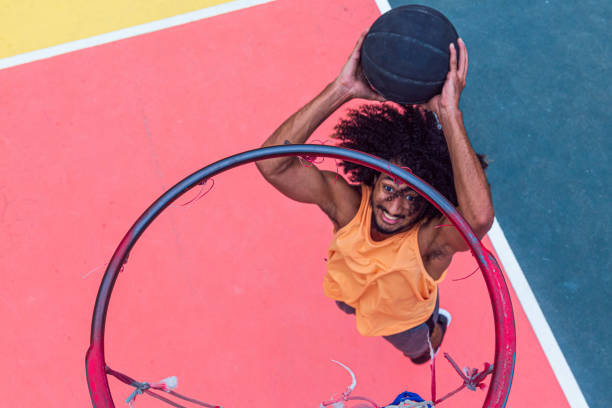 istock Young basketball player dunks on sport court 1289608534