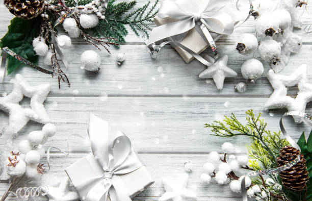 istock Christmas or winter composition. Frame made of  decorations on white wooden background. 1289610526