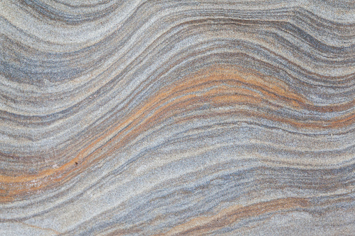 Abstract photograph of the colourful patterned rocks, showing detail of the geology at Spittal beach, Northumberland in North East England