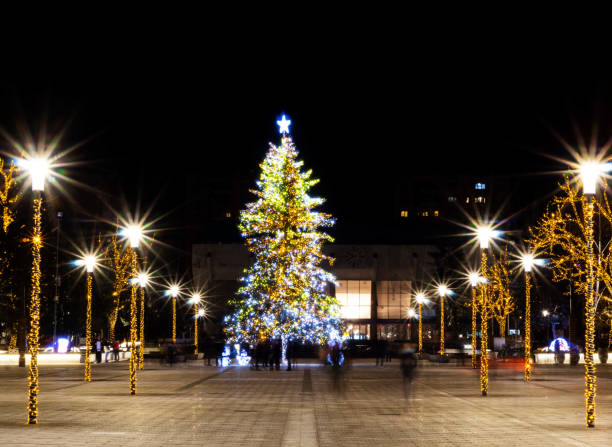 istock Christmas tree adorned with lights, surrounded by pillars with star shaped bulbs 1289614069