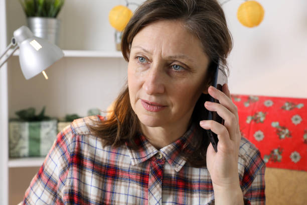 istock middle-aged woman uses a mobile phone. 1289617615