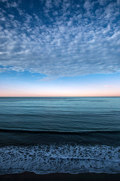 istock Sunrise over Pacific Ocean with Cumulus Clouds 1289617818