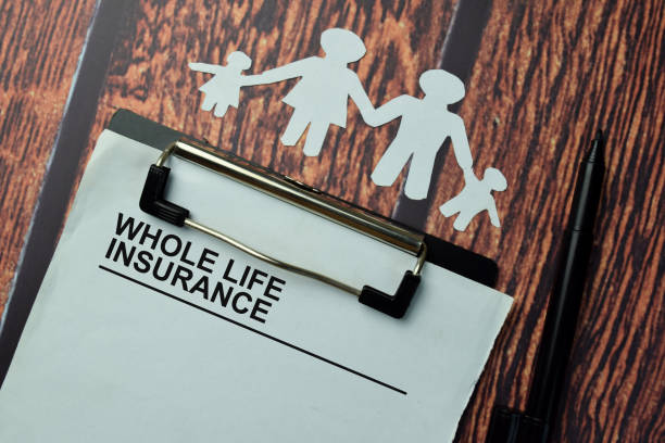 istock Whole Life Insurance write on a paperwork isolated on office desk. 1289619366