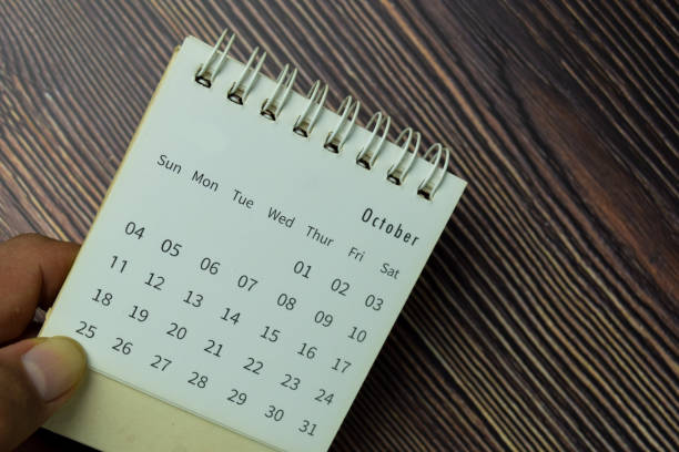 istock October on monthly Calendar isolated on the table 1289620058