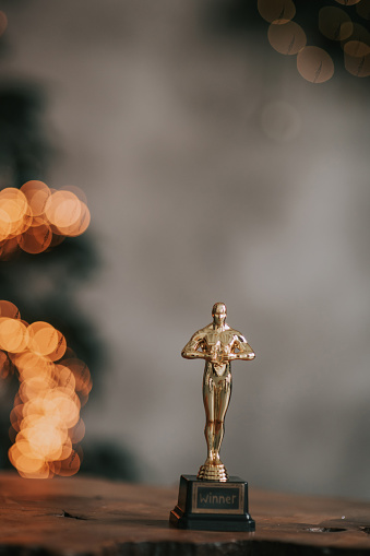 golden statuette of the winner on a beautiful bokeh background